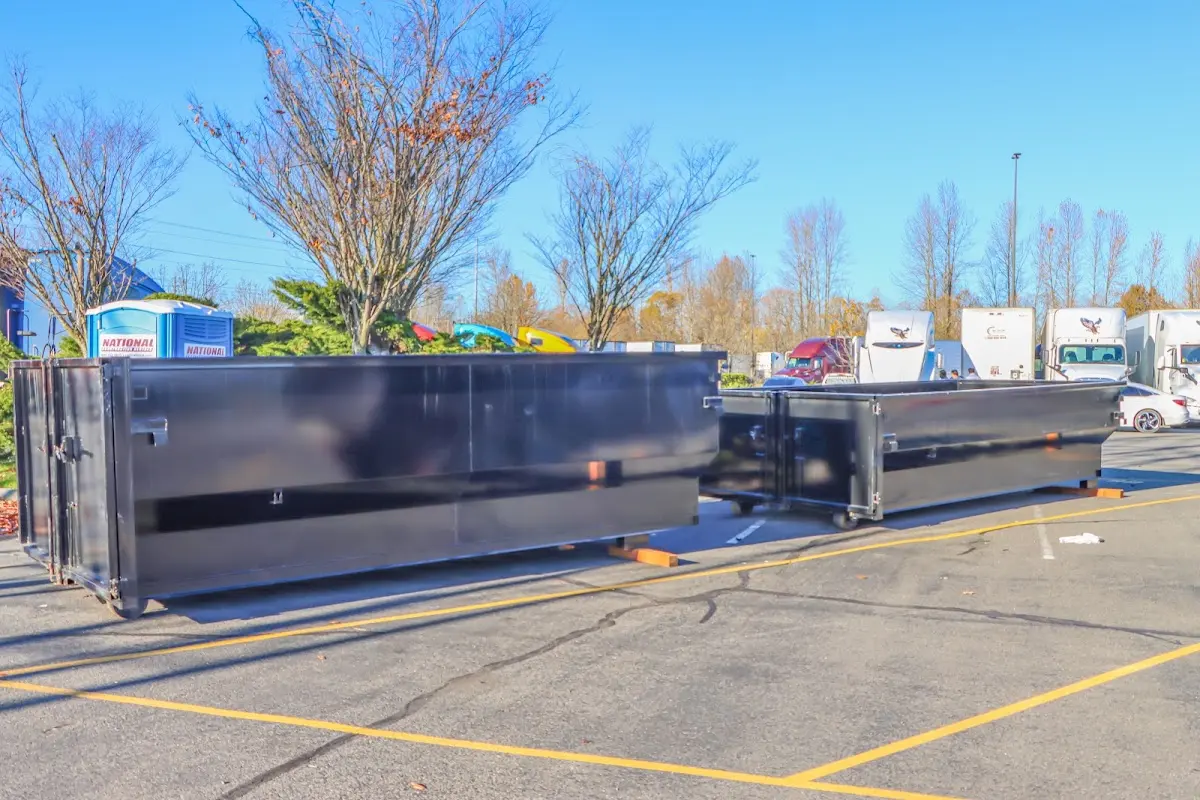 Professional dumpster rental service with roll-off container on residential driveway in La Mesa